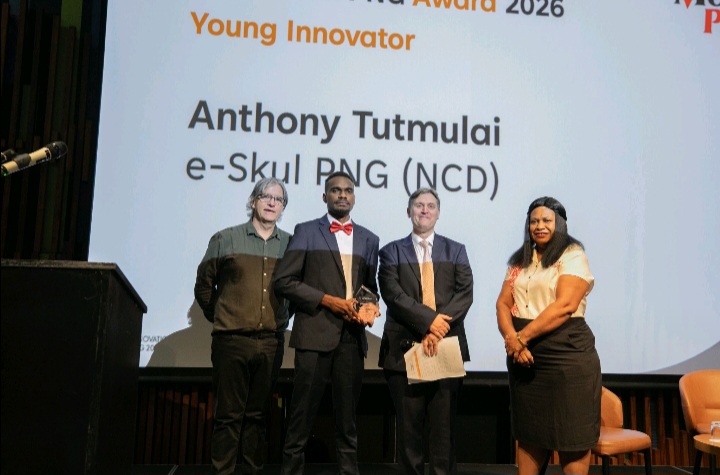 Anthony Tutmulai receiving the Young Innovator award for e-Skul PNG from Barbrah Paita of Moni Plus, in the presence of Peter Williams and Andrew Wilkins, at the Innovation PNG 2026 Awards